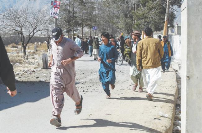 People run out of a polling station after a hand grenade attack in the vicinity of Sariab area, Quetta, on election day. Source: AFP