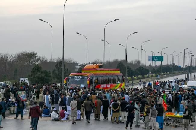 Supporters of Khan's Pakistan Tehreek-e-Insaf (PTI) party block the Peshawar-to-Islamabad highway as they protest thePakistan's national election results, in Peshawar on February 12, 2024 [Abdul Majeed/ AFP]